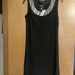 Black and gold sleeveless dress with sheer jacket.